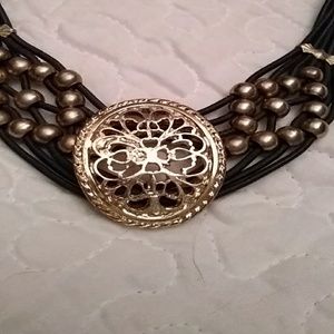 Leather and gold tone choker.